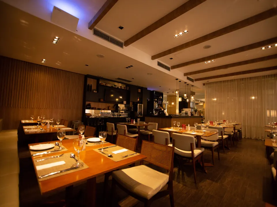 Comedor de un restaurante con las mesas puestas y luz cálida